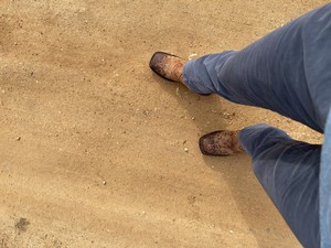 A man wearing cowboy boots from top view.