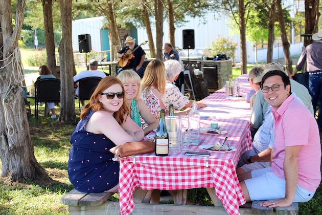 People sitting at picnic table outside